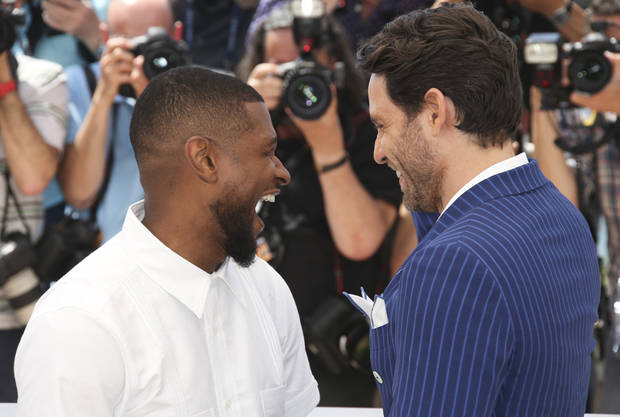 Actors Usher Raymond IV, left and Edgar Ramirez pose for photographers during a photo call for Hands of Stone at the 69th international film festival, Cannes, southern France, Monday, May 16, 2016. (AP Photo/Joel Ryan)